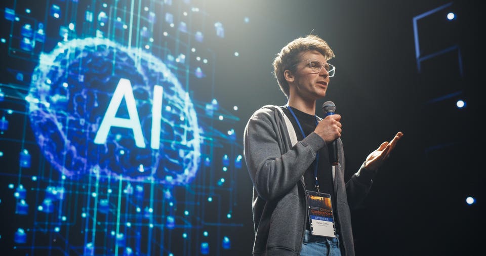 AI Startup Founder Talking About Innovations in the World of Artificial Intelligence and Large Language Models. Young Caucasian Man Talking About Future Technology Insights on Stage at a Global Event