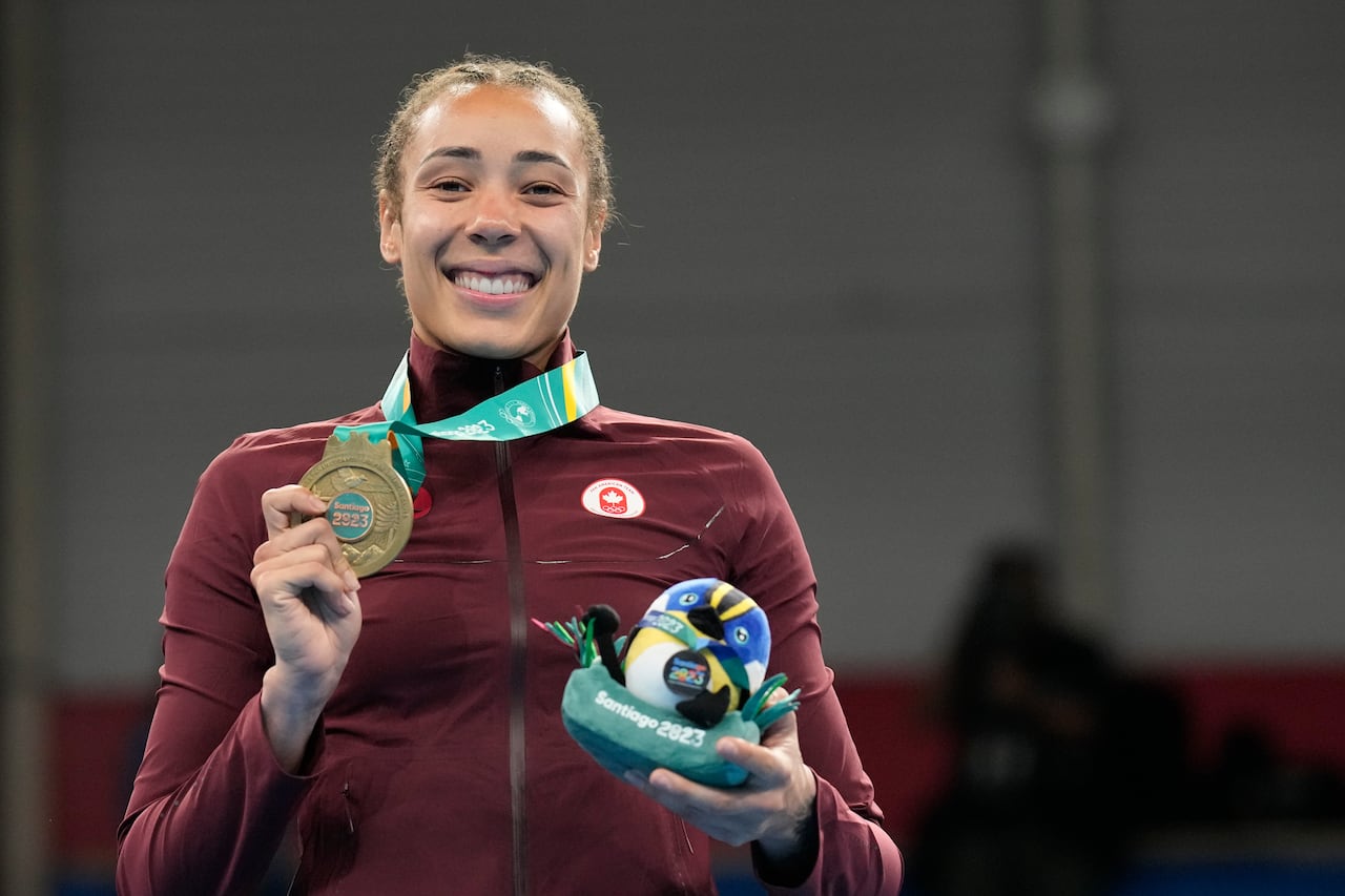 A boxer shows her medal.