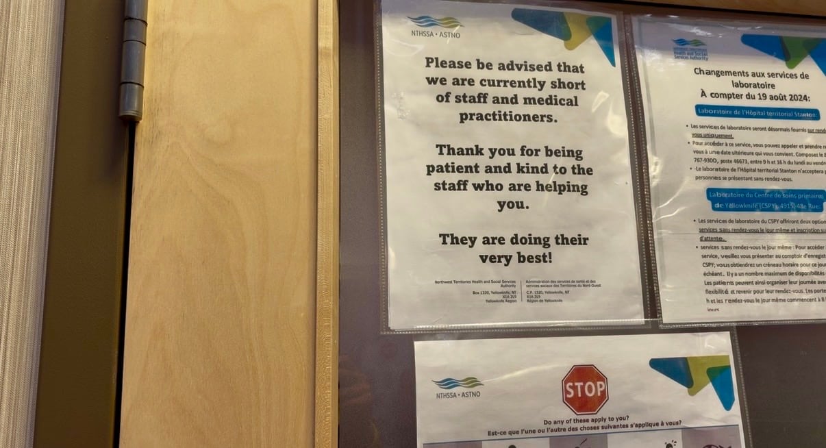 A sign on a door in an office building.