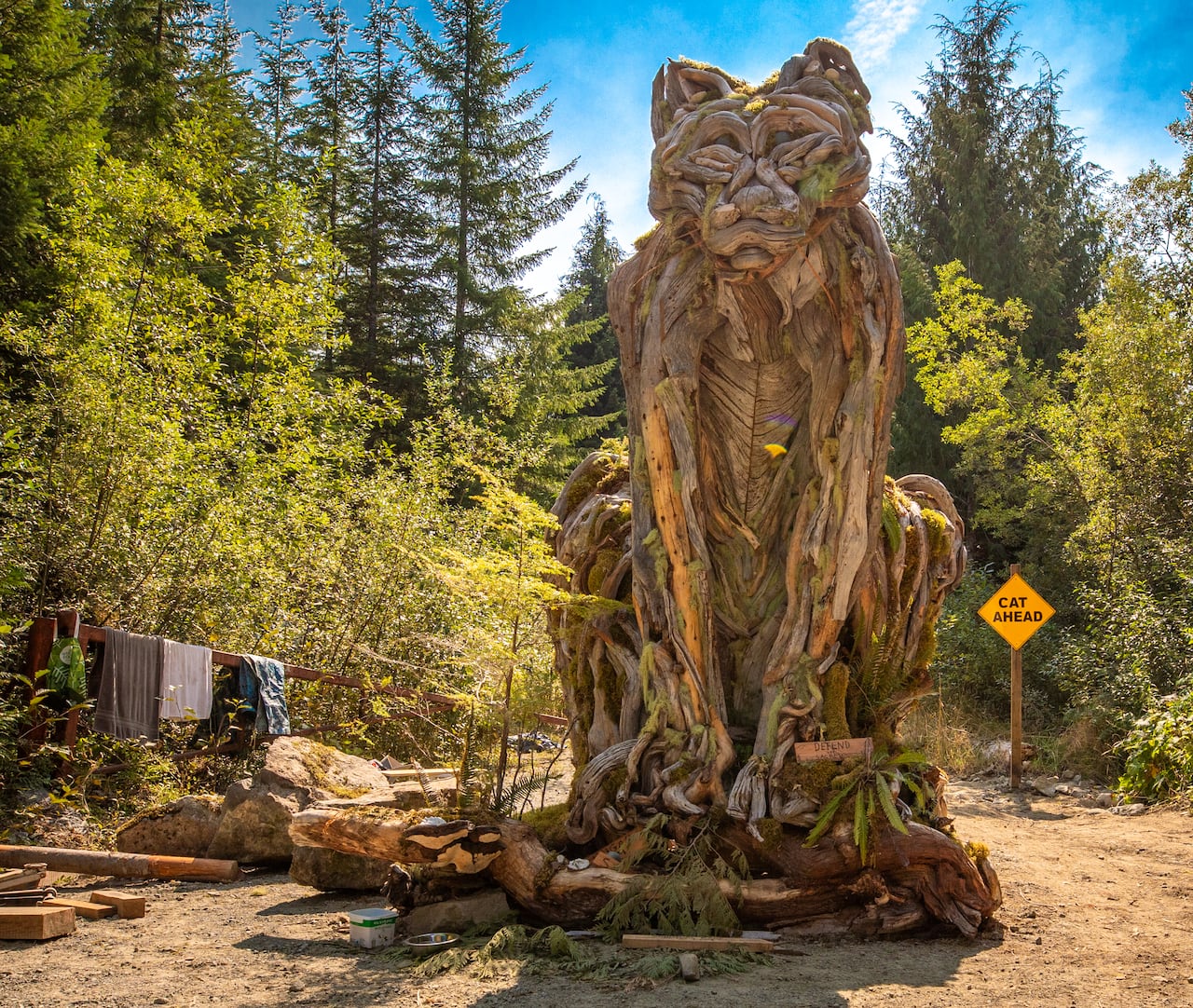 A large cougar sculpture made of a tree stump.