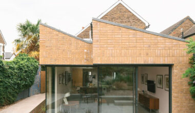 sawtooth roof and textured brick facade reimagine victorian home in the uk