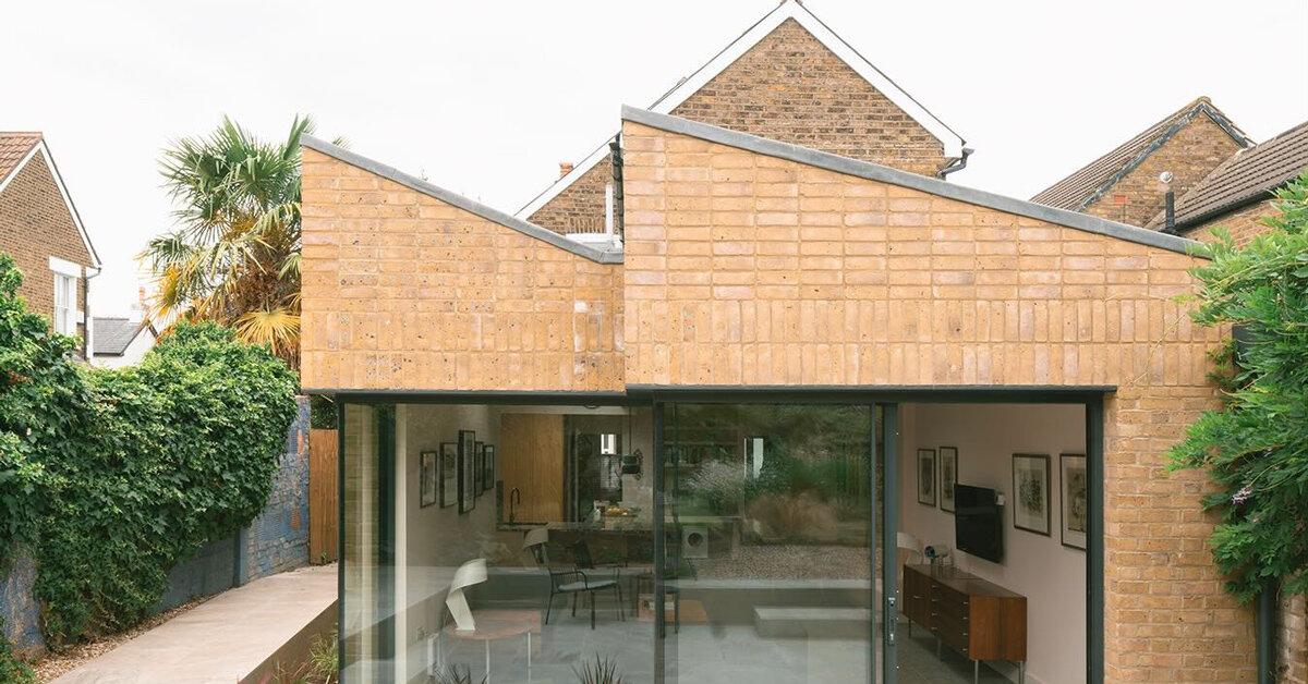 sawtooth roof and textured brick facade reimagine victorian home in the uk