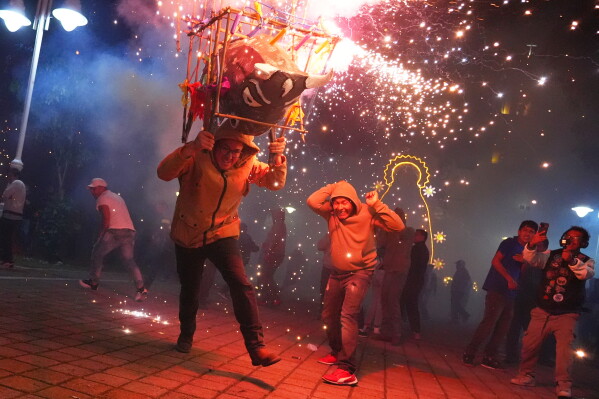 Revelers react to fireworks shooting off a traditional "Torito" during town festivities in Tepexpan, Mexico, Monday, Aug. 3, 2026. (AP Photo/Julio Cortez)