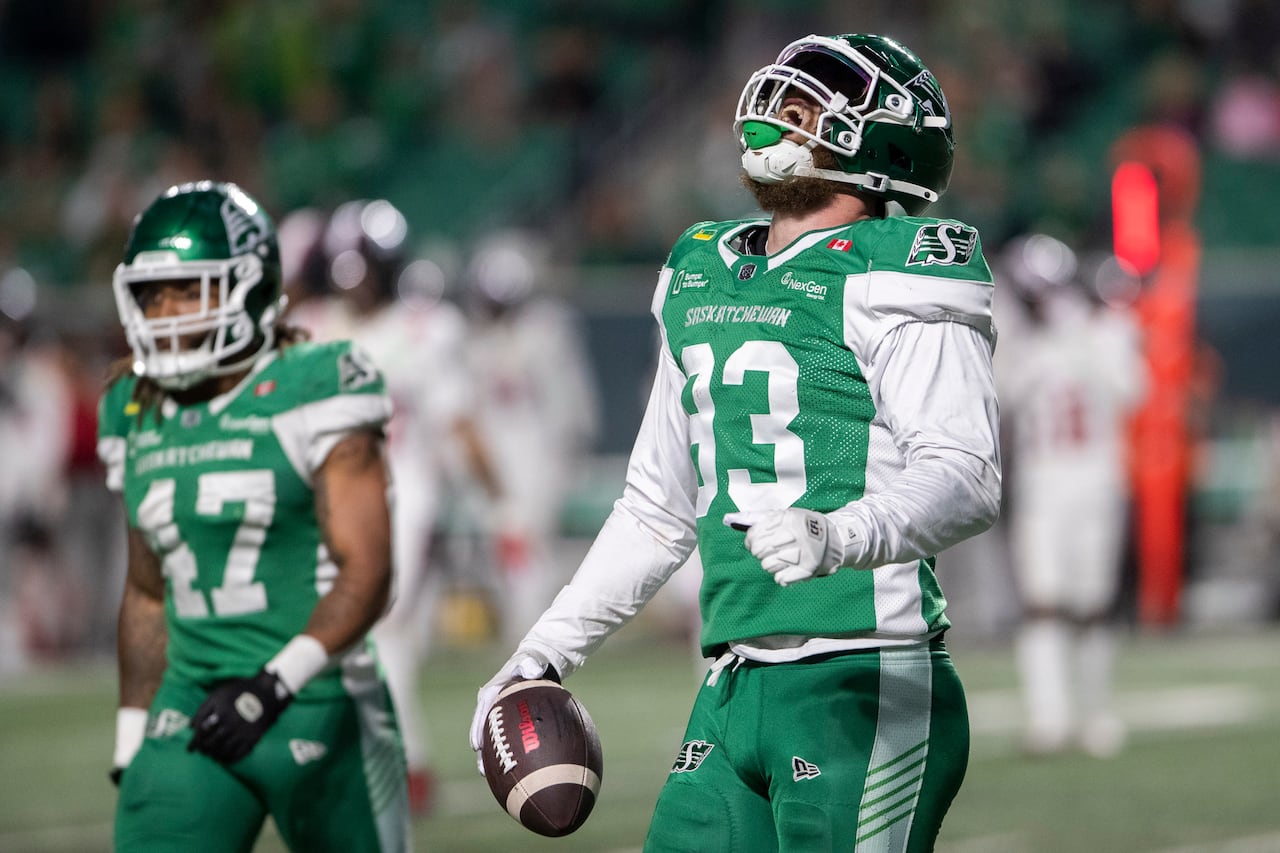 Saskatchewan Roughriders defensive lineman Benoit Marion (93) is yelling in celebration, his head turned up to the sky.