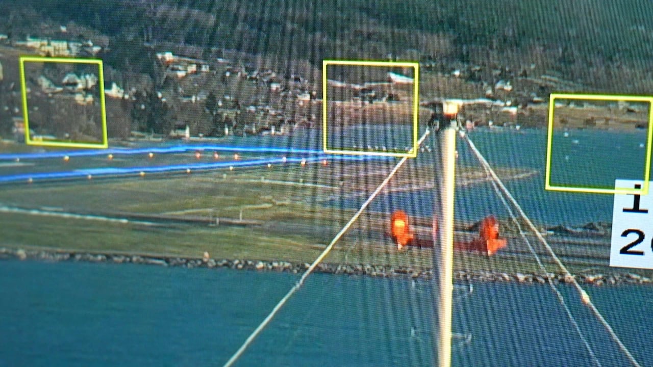 An image of a runway with yellow boxes around small white objects in the air