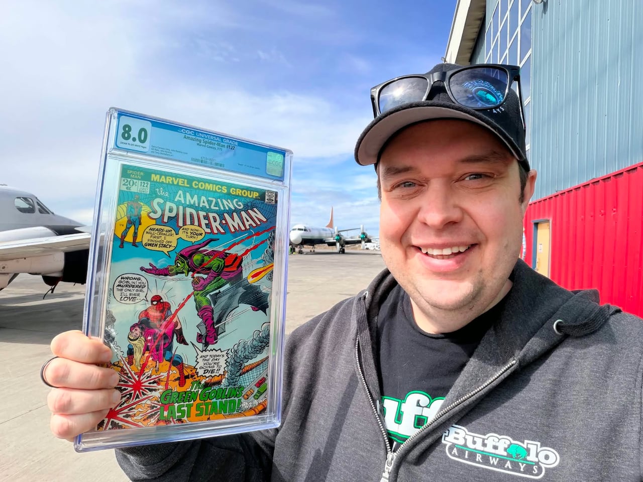 Man holding a Spider-Man comic