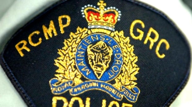 A shoulder badge says RCMP GRC over a coat of arms.