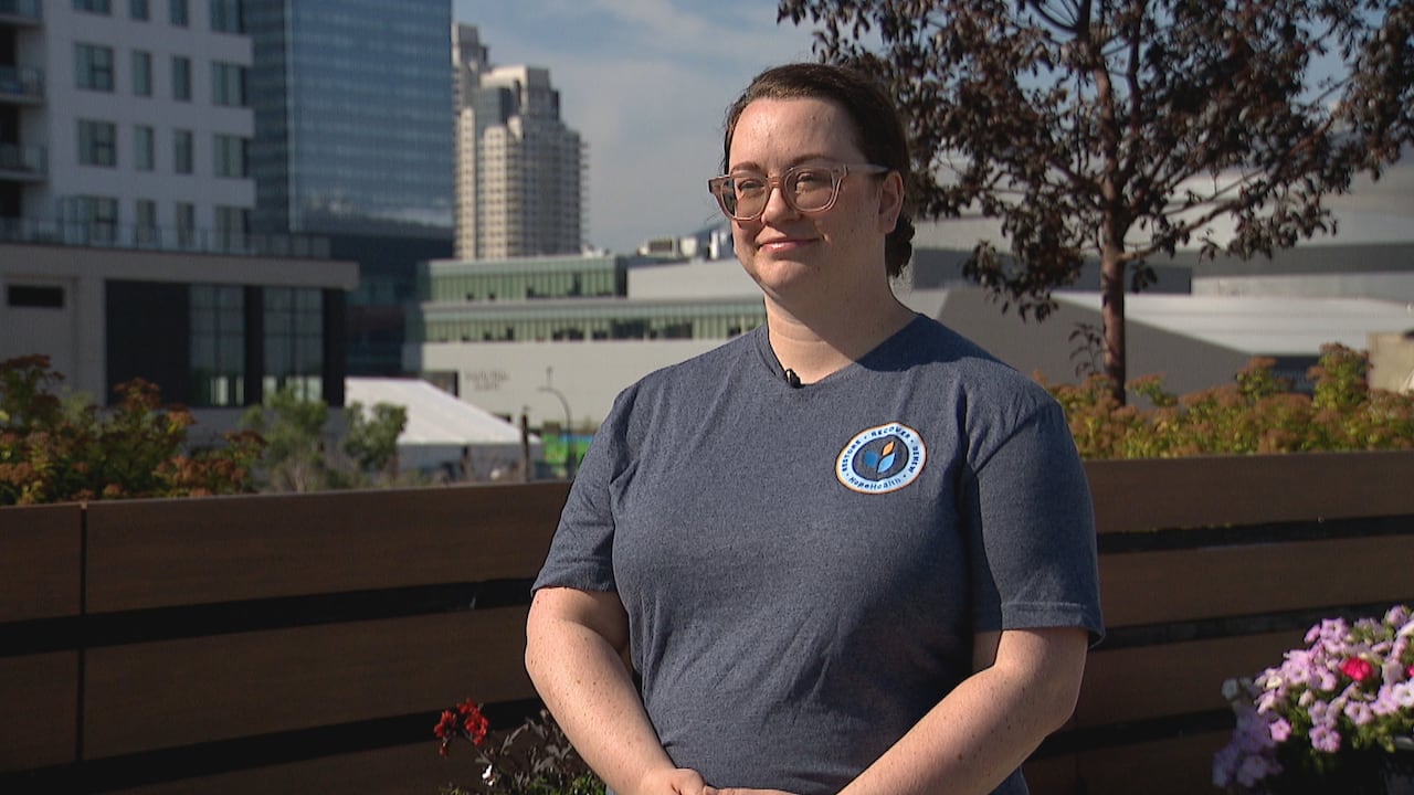 Woman in glasses speaking to CBC reporter off camera