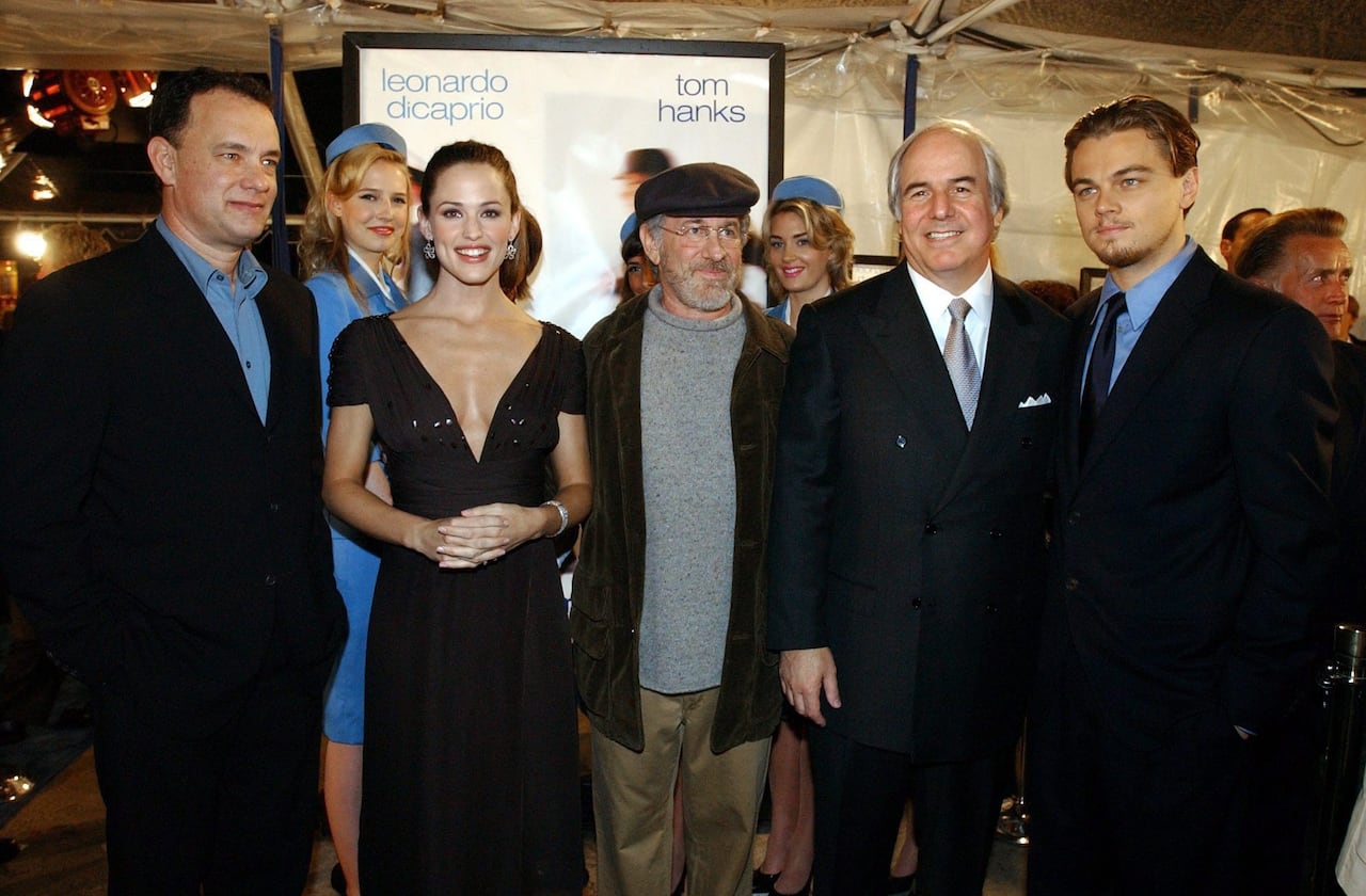 Five people pose side by side at a movie premiere event