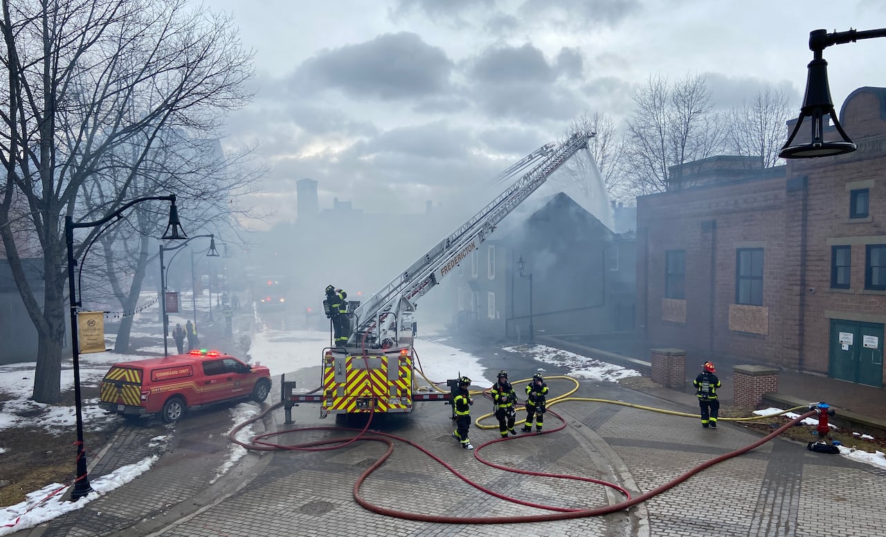Firefighters battle a fire on Carleton Street in Fredericton.