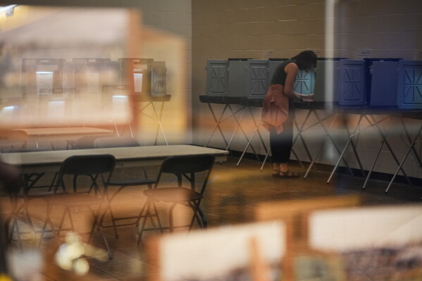 A voter casts her ballot on primary Election Day Tuesday, Aug. 11, 2026, in Minneapolis. (AP Photo/Ellen Schmidt)