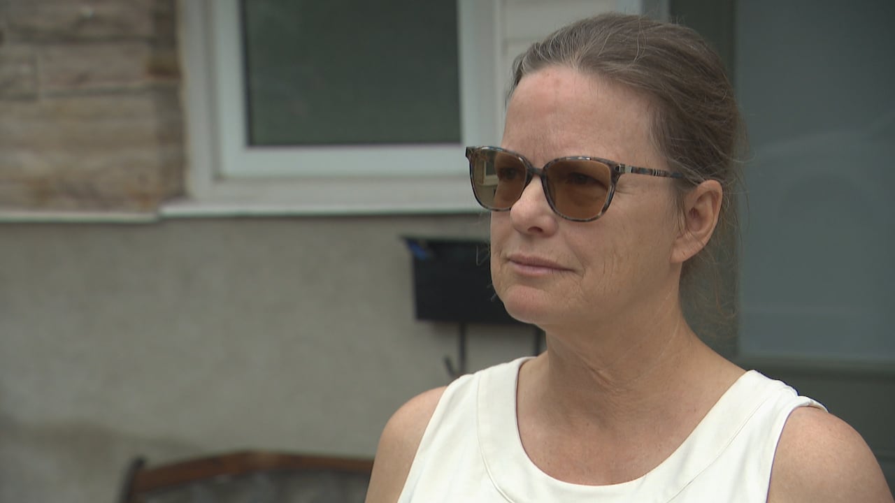 Woman in white shirt with a straight face