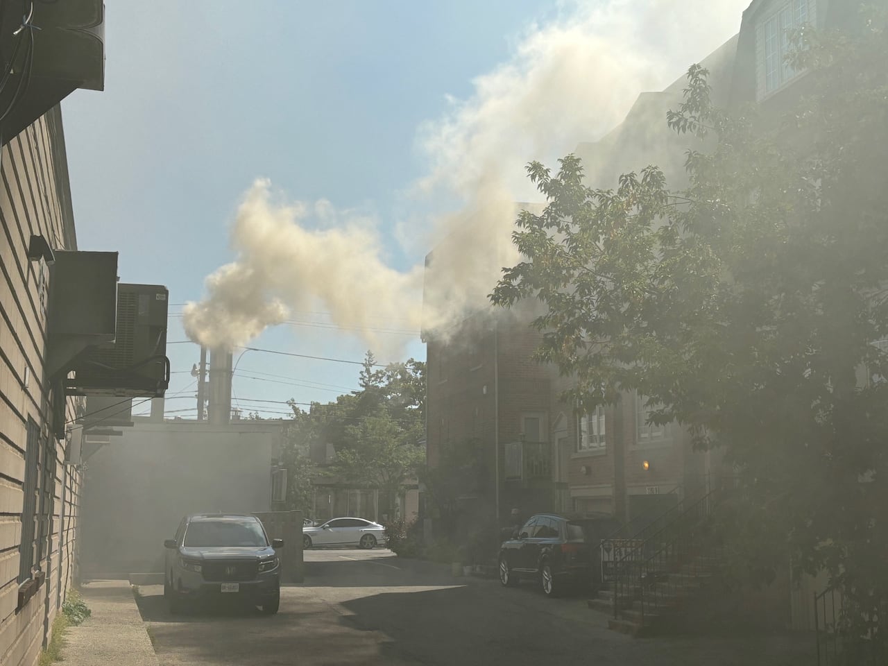 Thick, pungent smoke wafts from the smokestack of the Beach Hill Smokehouse into a residential laneway in this picture from 2024.