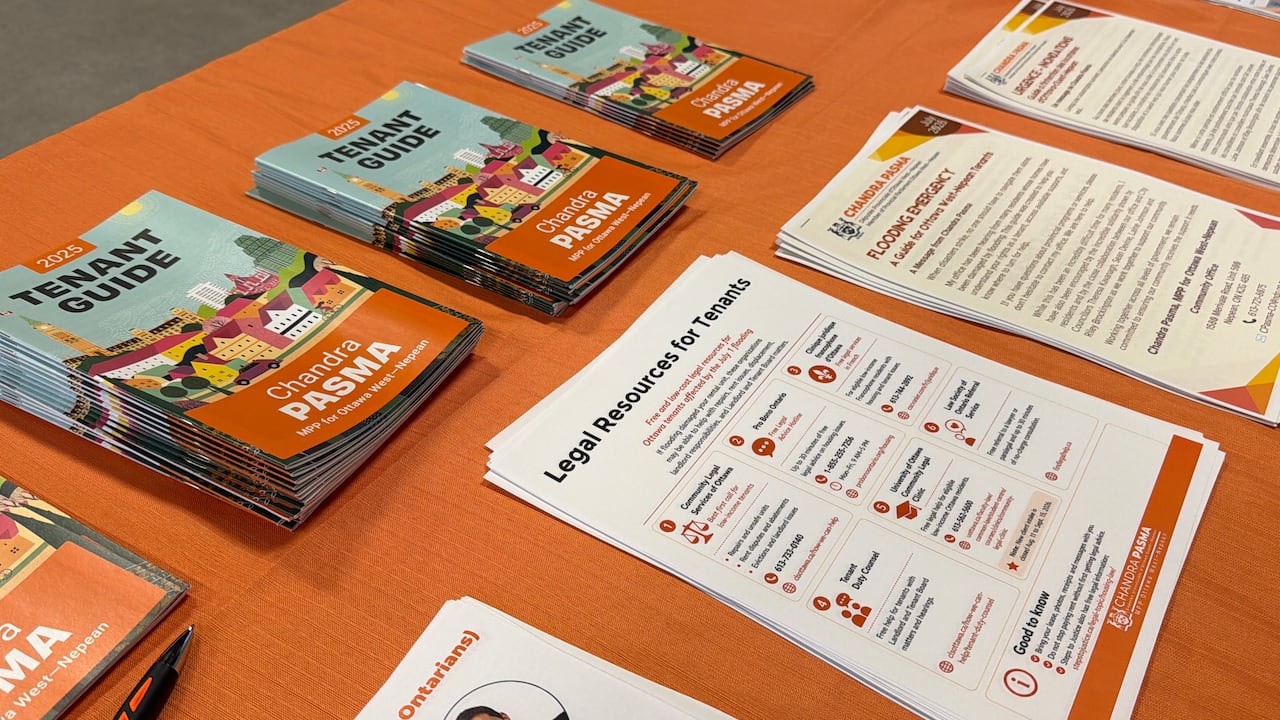 A collection of white and orange pamphlets on a table.