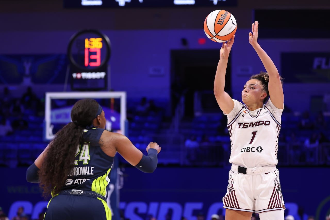 A basketball player shoots.