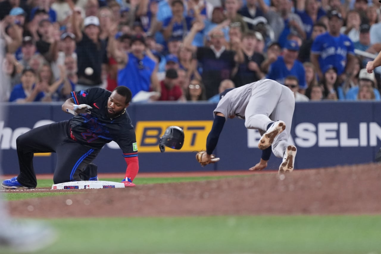 Blue Jays infielder Vladimir Guerrero Jr. and Yankees shortstop George Lombard Jr. in the aftermath of a collision during a game at Toronto's Rogers Centre.