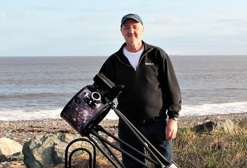 Chris Curwin poses with a telescope