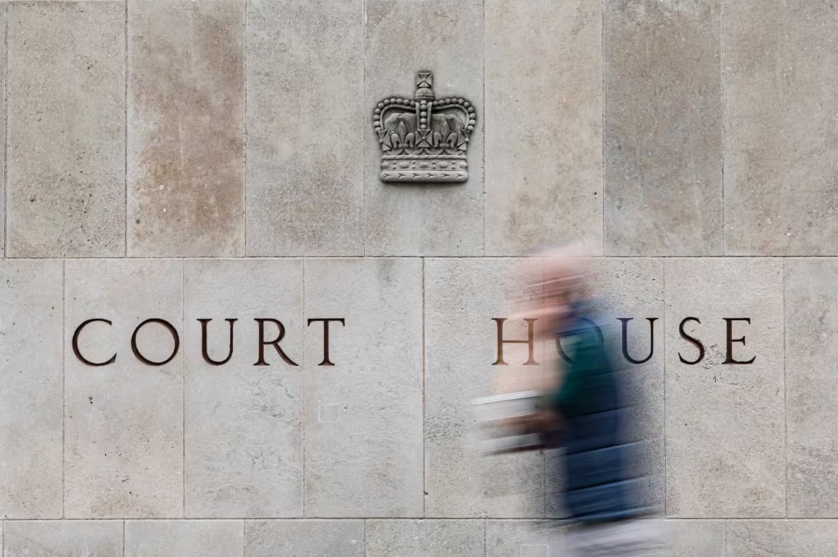 A person walks by an Ontario courthouse.