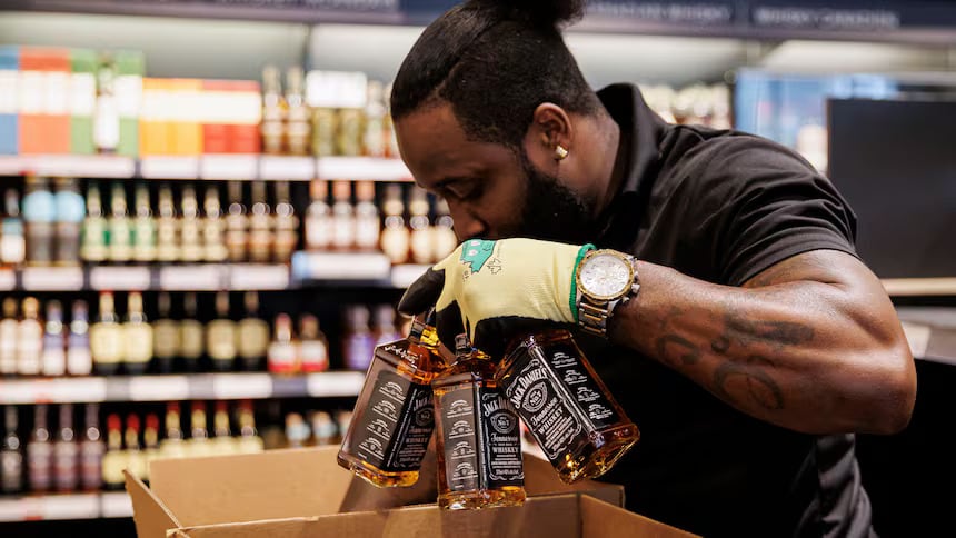 Staff at a Toronto LCBO remove American wine and spirits from store shelves in March of last year.