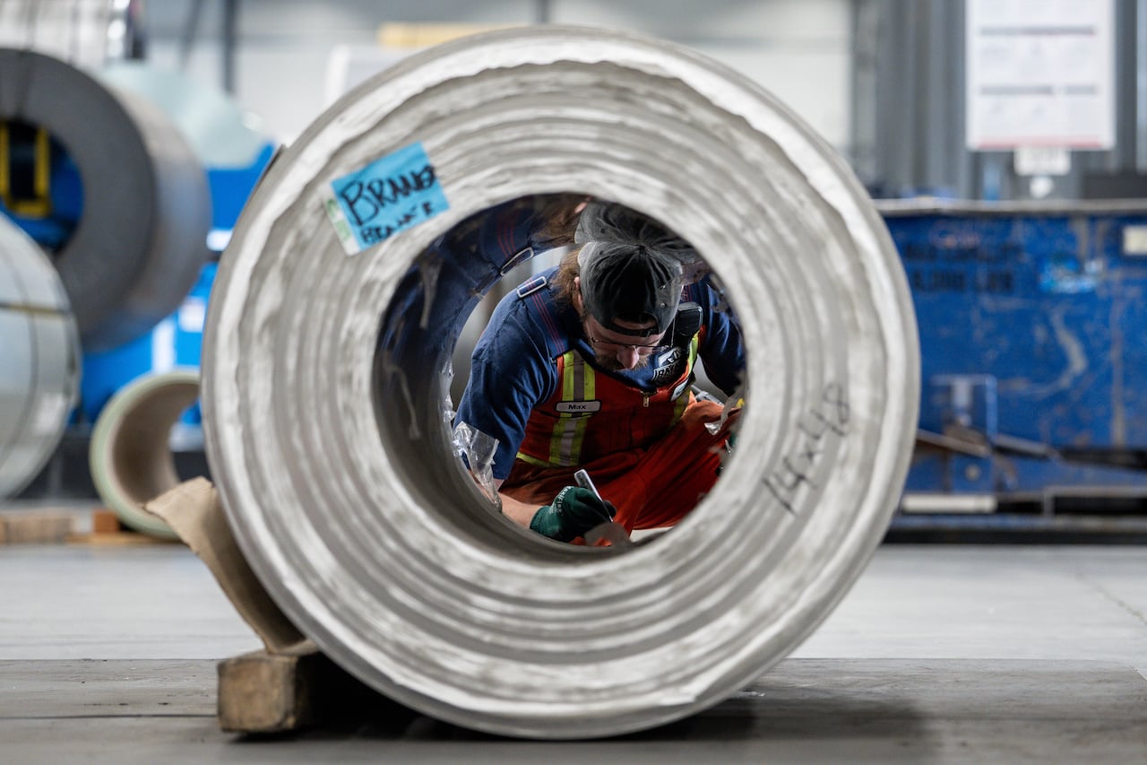 A worker tags a roll of steel at Cascadia Metals in Delta, B.C., on Friday, August 14, 2026.