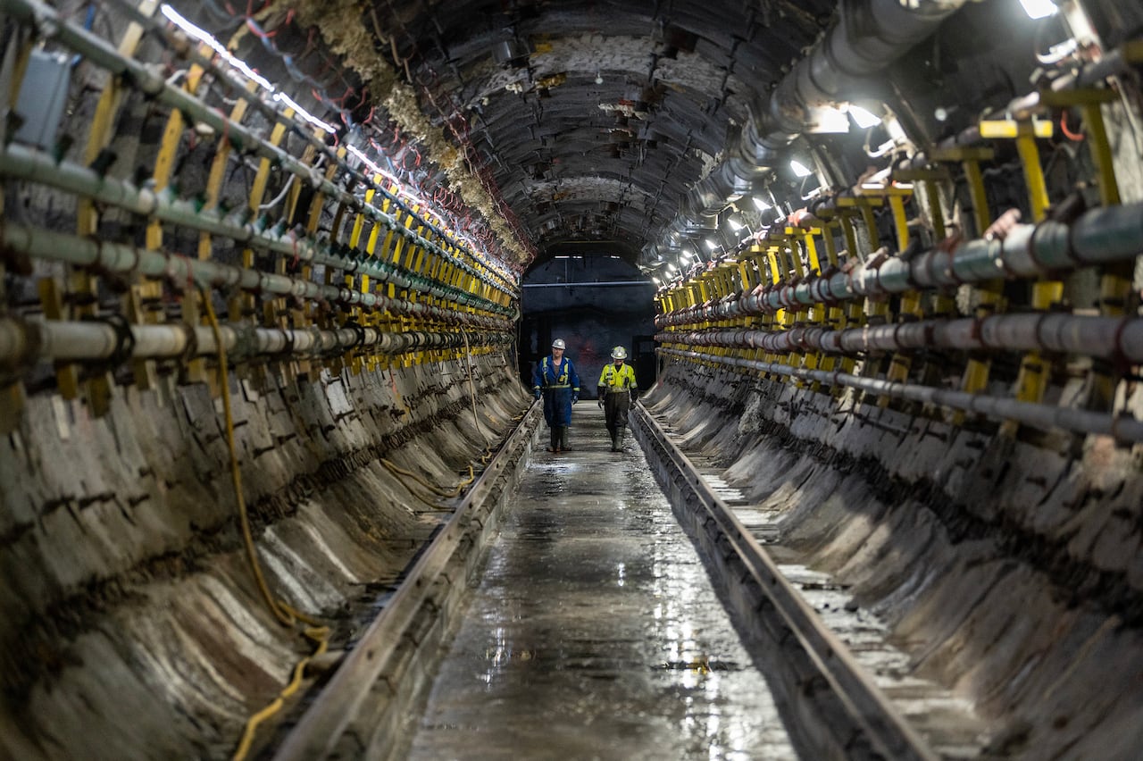 Cameco employees walk down a tunnel to a Jet Boring System (JBS) machine during a media tour of Cameco's Cigar Lake uranium mine in Cigar Lake, Sask.