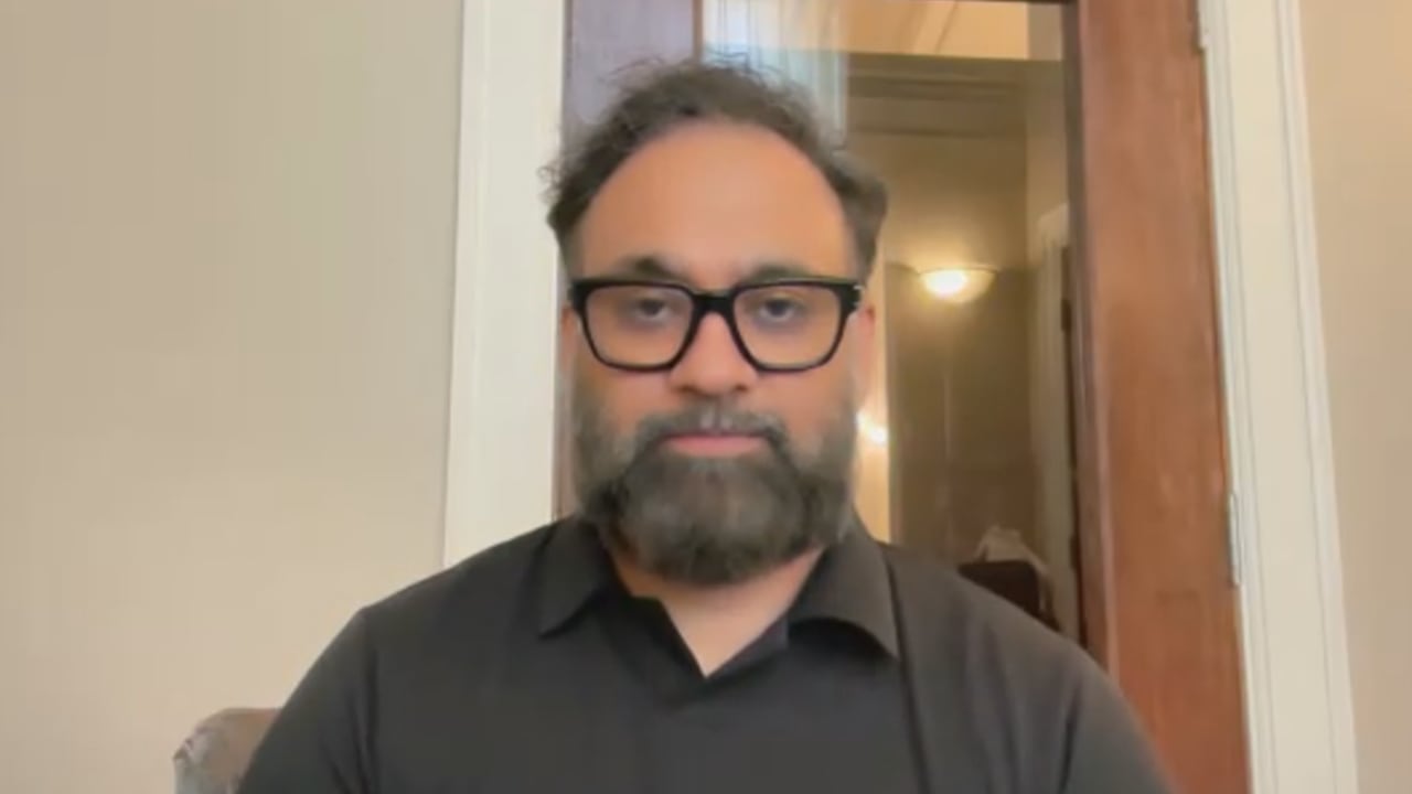 Screenshot from a Zoom call showing a man in black shirt