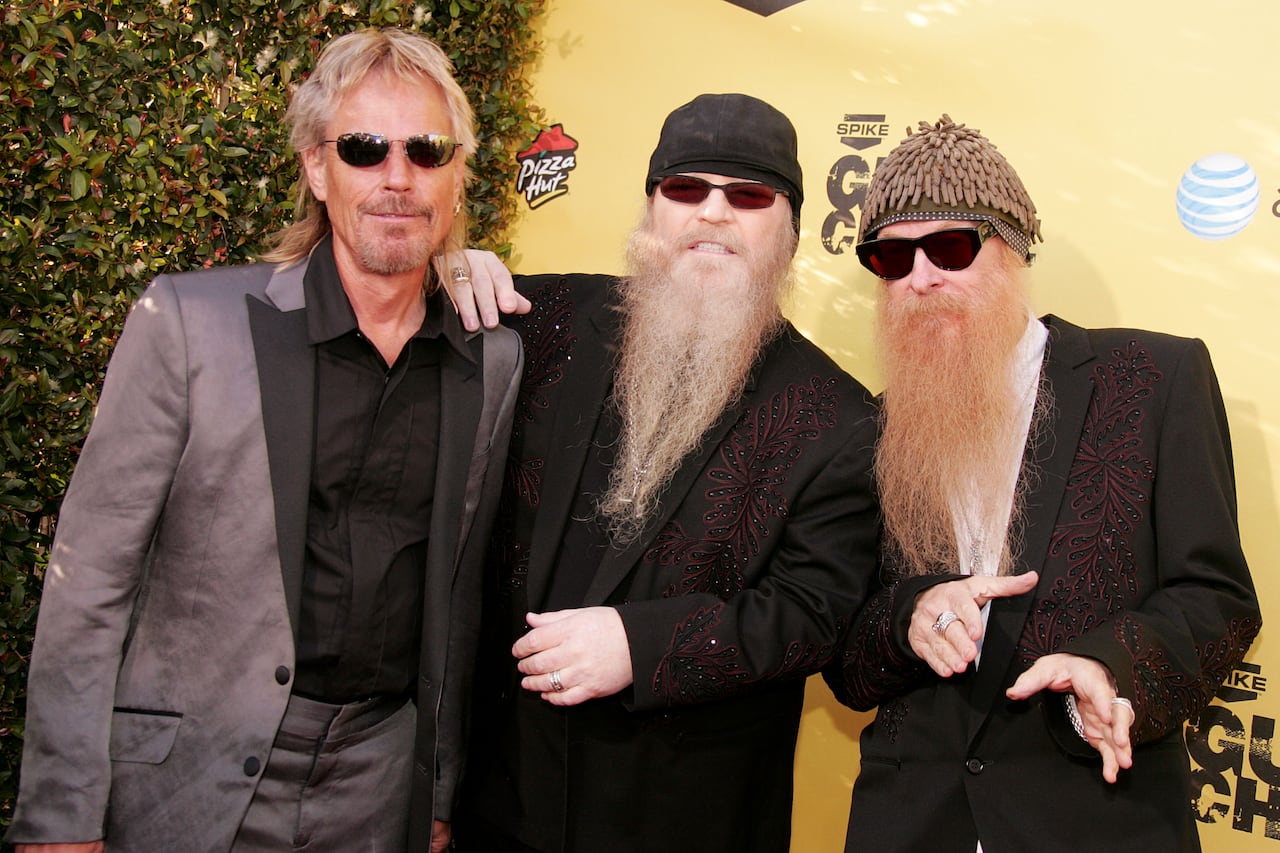 Three men in dark glasses, two with long beards