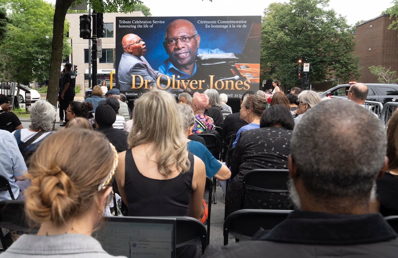 An overflow of people watch on an outdoor giant screen as they attend the funeral of Quebec jazz musician Oliver Jones at Union United Church in Montreal on Thursday, Aug. 20, 2026. The award-winning pianist died July 22 at age 91.