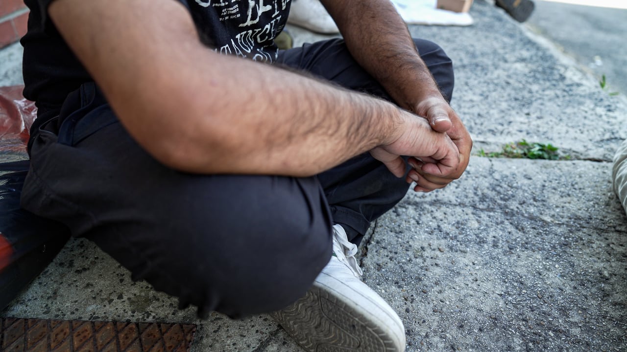 A man sits cross-legged.