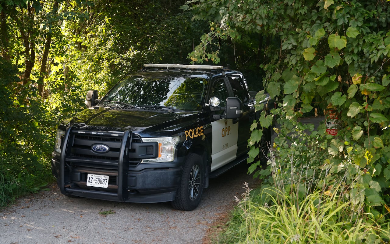 An Ontario Provincial Police vehicle sits at the entrance to a property on Kelly Jordan Road near Smiths Falls, Ont., where the body of missing man, Lawrence Bertrim, was found, on Tuesday, Aug. 18, 2026.