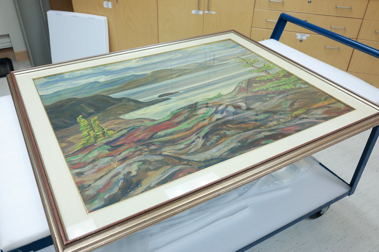 A large canvas painting on a trolley