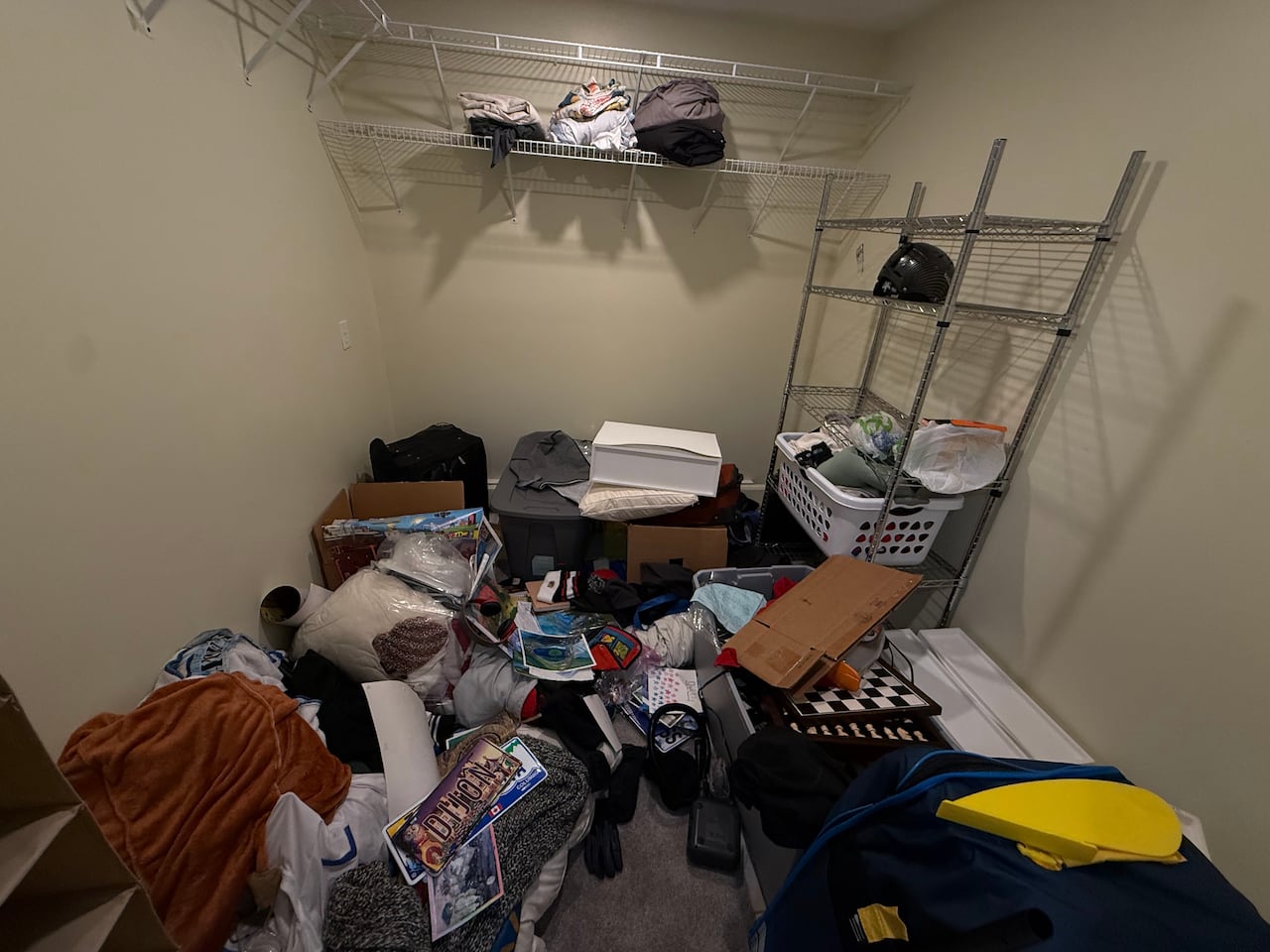 A closet is pictured in a messy state.