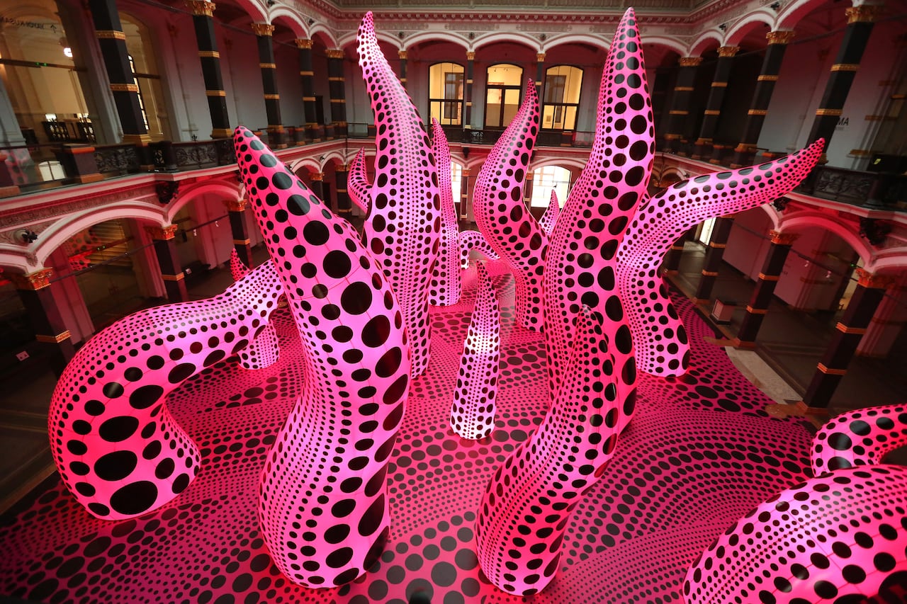 An pink art installation covered in black polka dots