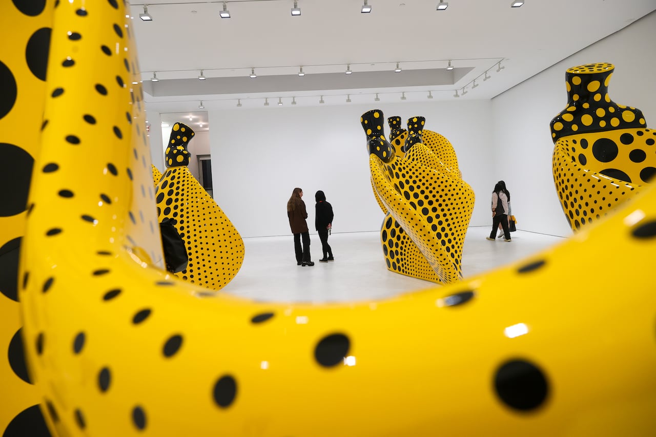 A picture of a yellow art installation covered in black polka dots