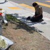 Nicole Witherow prays beside flowers placed outside the Islamic Center of San Diego on May 19.
