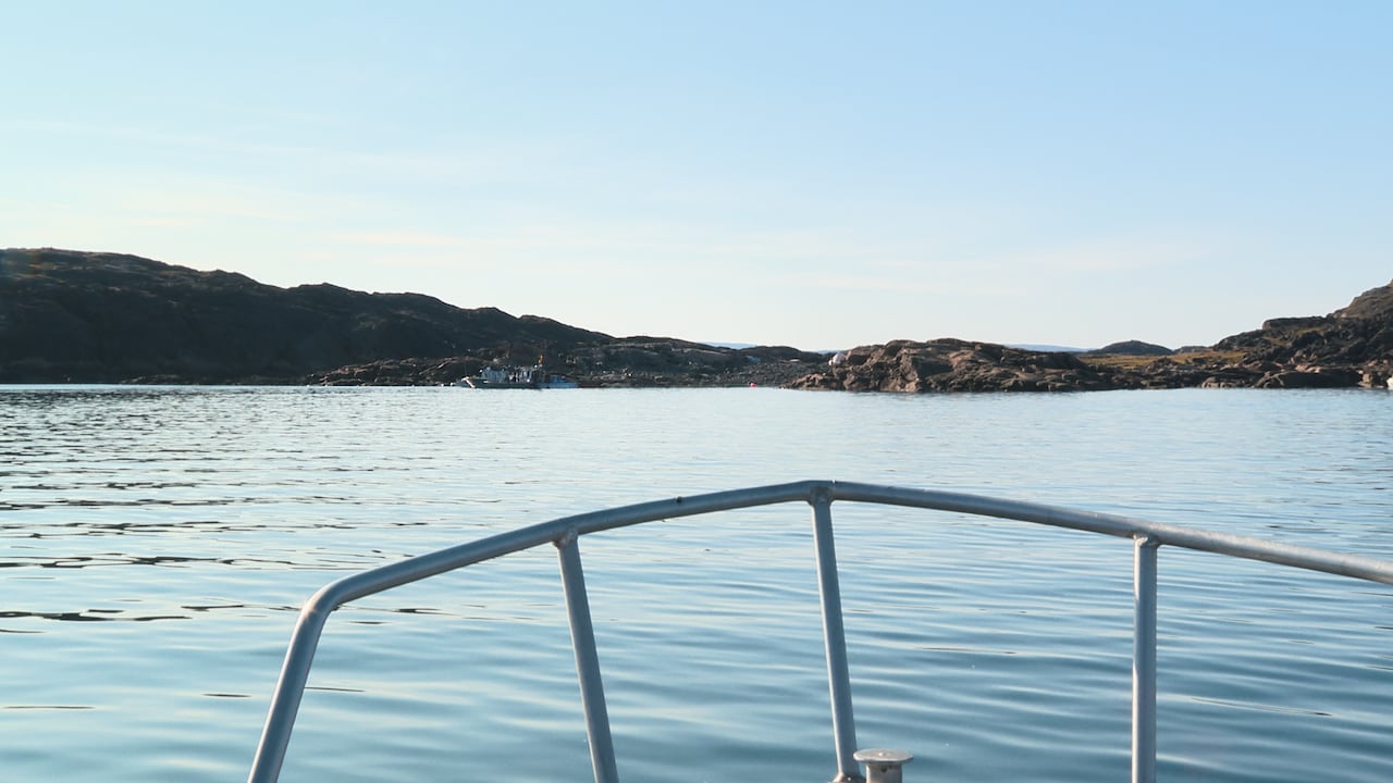 Land is seen in the distance past open water.