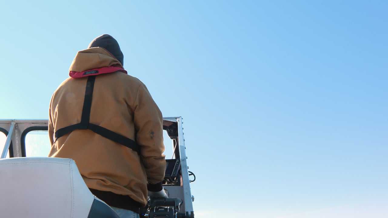 Back of man driving boat