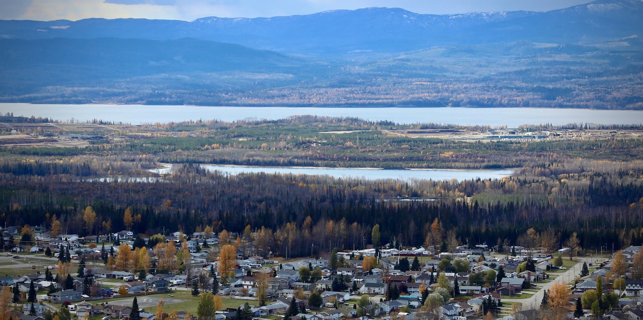 A small town is seen along the shores of a large lake.