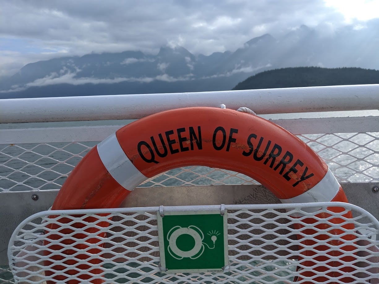 A life preserver mounted on a ferry. It reads 'Queen of Surrey'