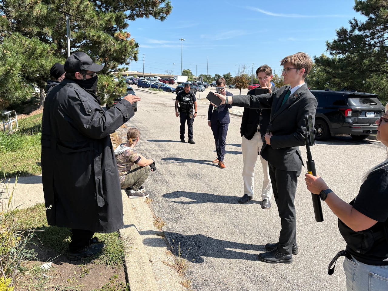 Max Genest, who identified himself as a Dominion Society member, confronts a protester in front of The Atrium Banquet and Conference Centre in Burlington on Saturday.