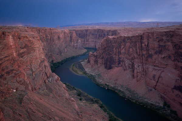 The Colorado River flows near the Glen Canyon Dam, July 15, 2026, near Page, Ariz. (AP Photo/John Locher, File)