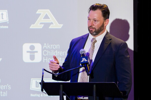 This photo provided by the University of Akron shows University of Akron athletic director Dr. Andrew Goodrich speaks at an event announcing the finalists for the, "Offensive Coordinator of the Game," promotion on Wednesday, Aug. 19, 2026, in Akron, Ohio. (University of Akron via AP)