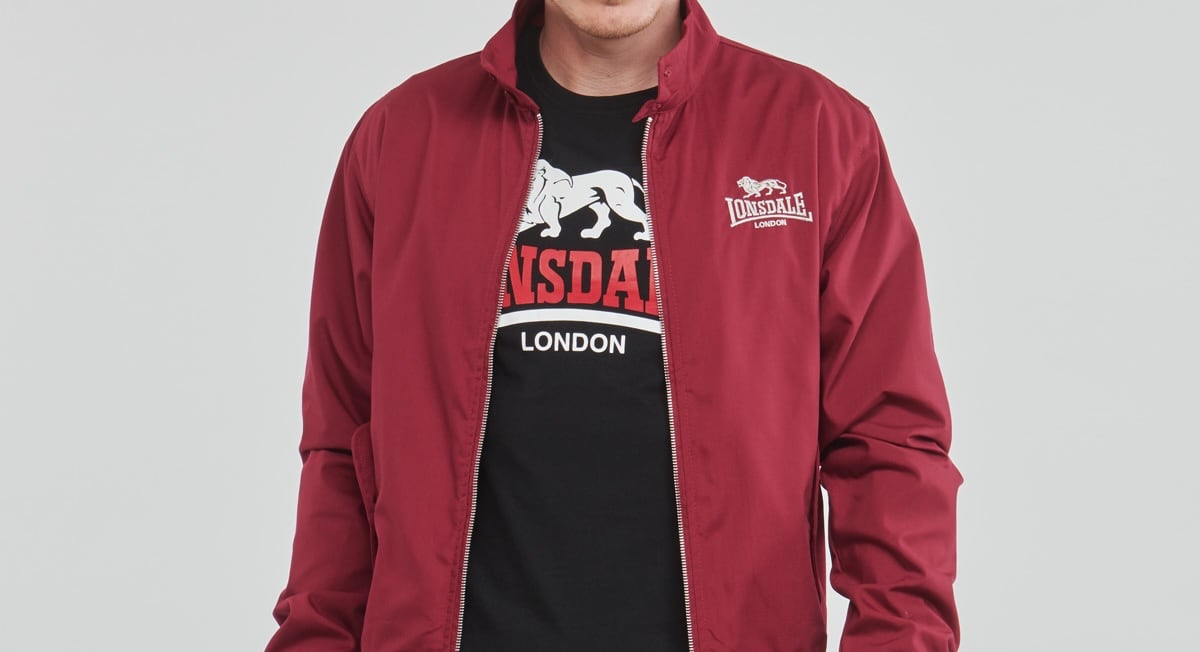 A t-shirt is seen under a red jacket for the brand Lonsdale. The visible letters make up NSDA.