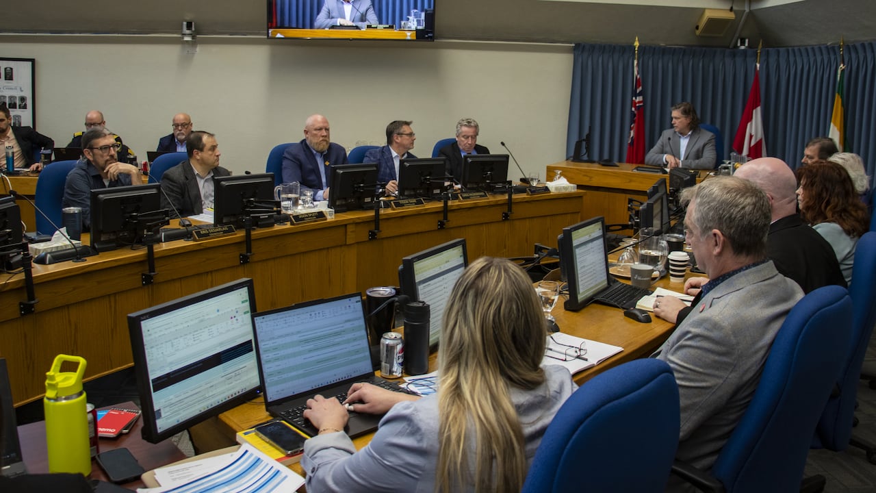 A council chamber with people working.