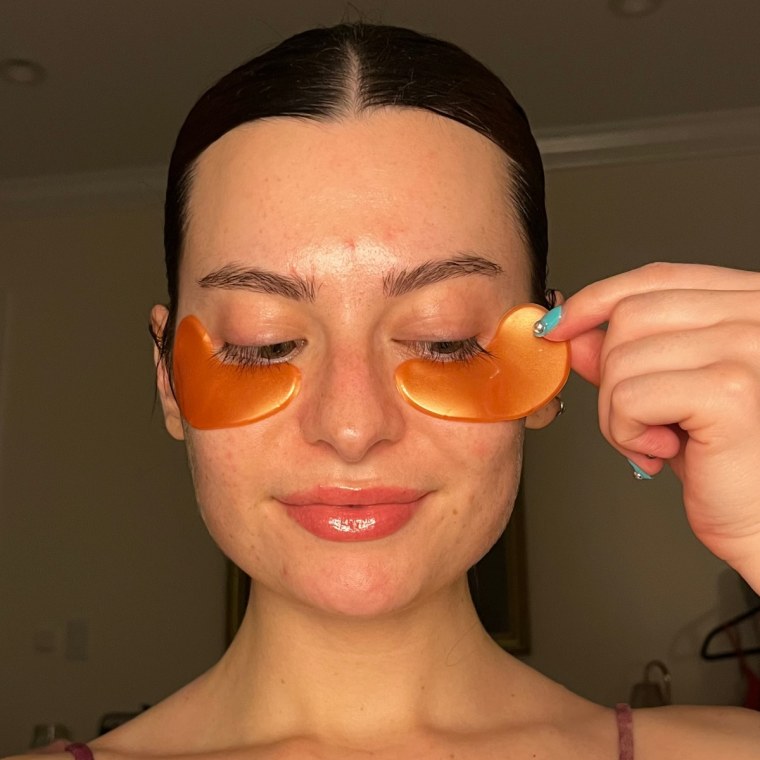 Associate market editor Audrey Ekman applies the Grace & Stella Brightening Vitamin C Eye Masks.