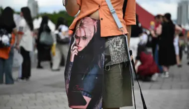 A fan wears a poster of one of the members of K-pop boy band Stray Kids before attending a concert in Seoul on July 25.