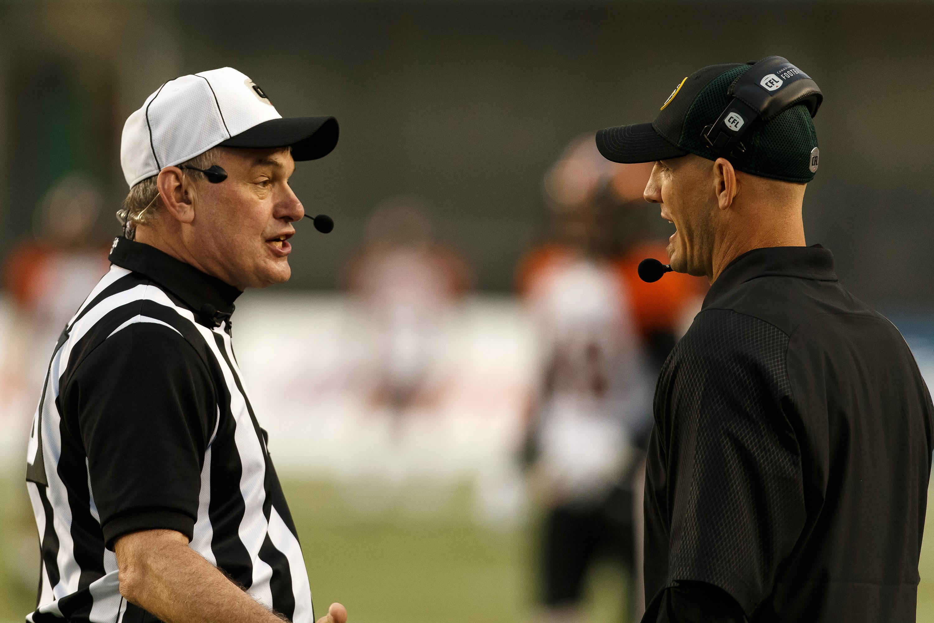 A football coach gets into a heated discussion with an official.