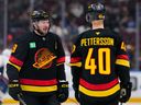 J.T. Miller #9 of the Vancouver Canucks skates past Elias Pettersson in a January 2025 game against the Washington Capitals at Rogers Arena.