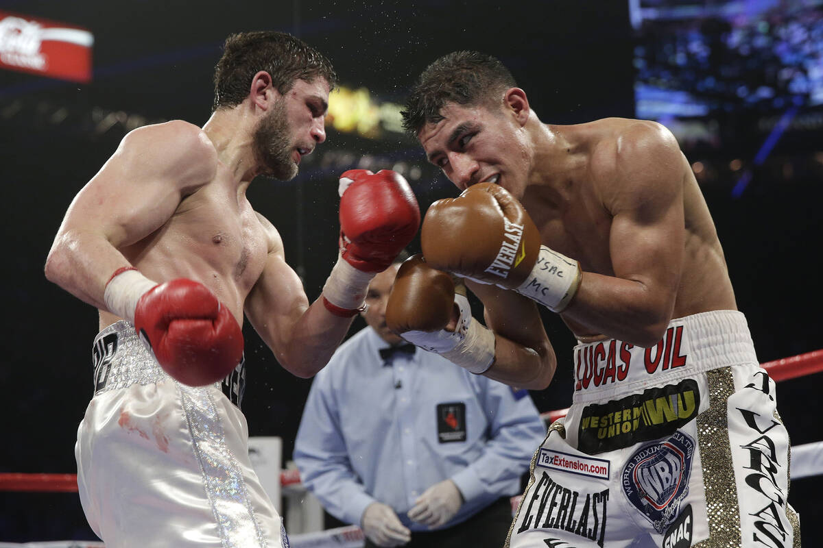 Khabib Allakhverdiev, left, from Russia, and Jessie Vargas, of the United States, trade punches ...
