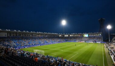 Saputo Stadium at night with Montreal's Olympic Stadium visible in the background